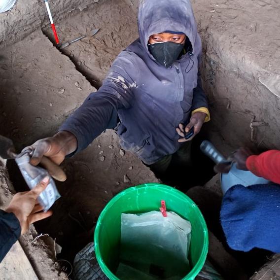 A researcher excavating underground in Malawi
