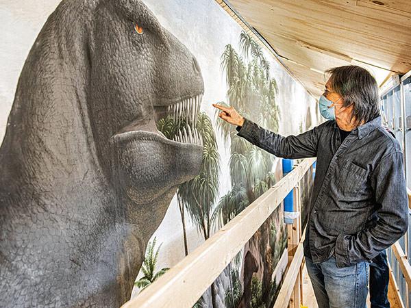 Armand Morgan with The Age of Reptiles mural; Photo by Dan Renzetti