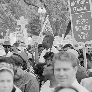 People marching and holding signs for the National Council for Negro Women